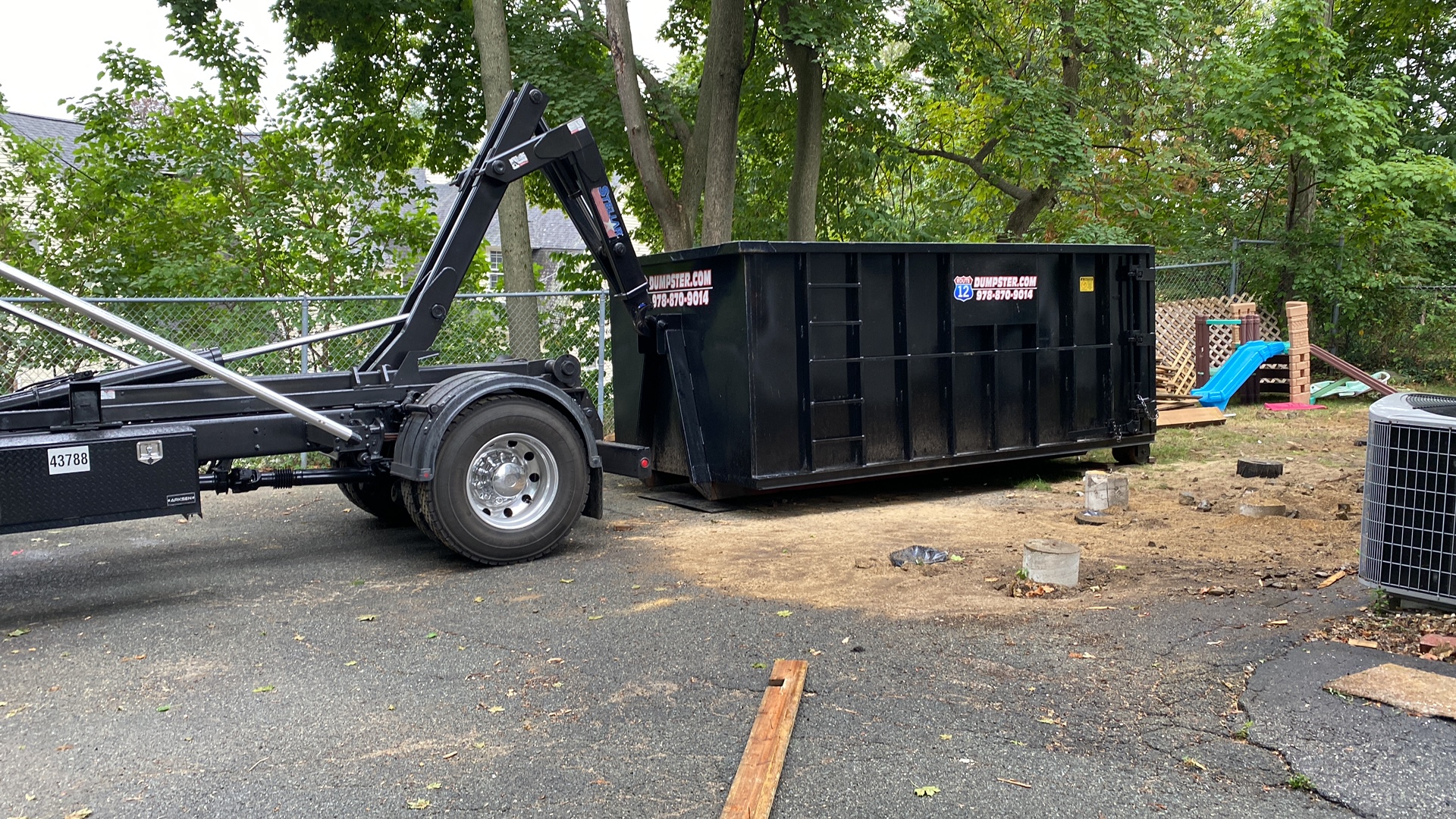 Route 12 roll-off dumpster set down in a backyard