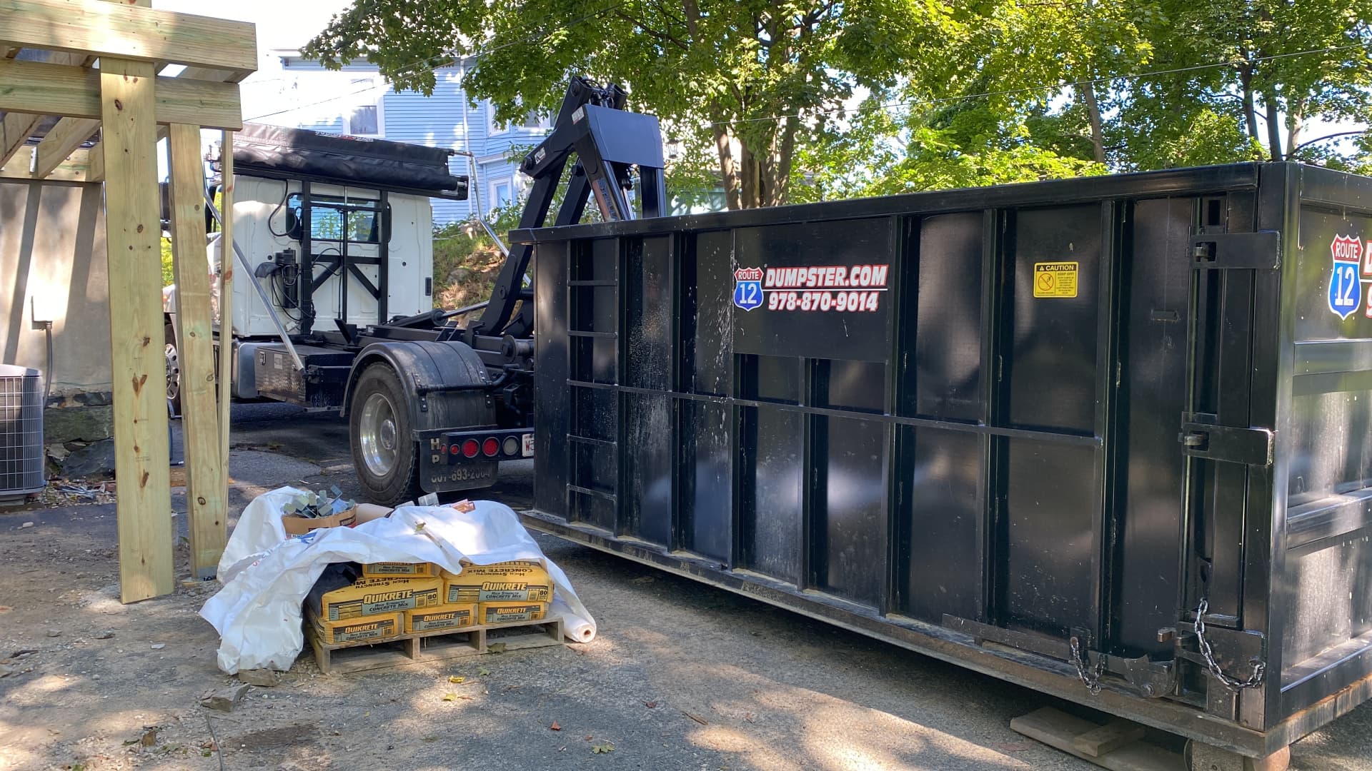 Route 12 dumpster at a home deck construction project