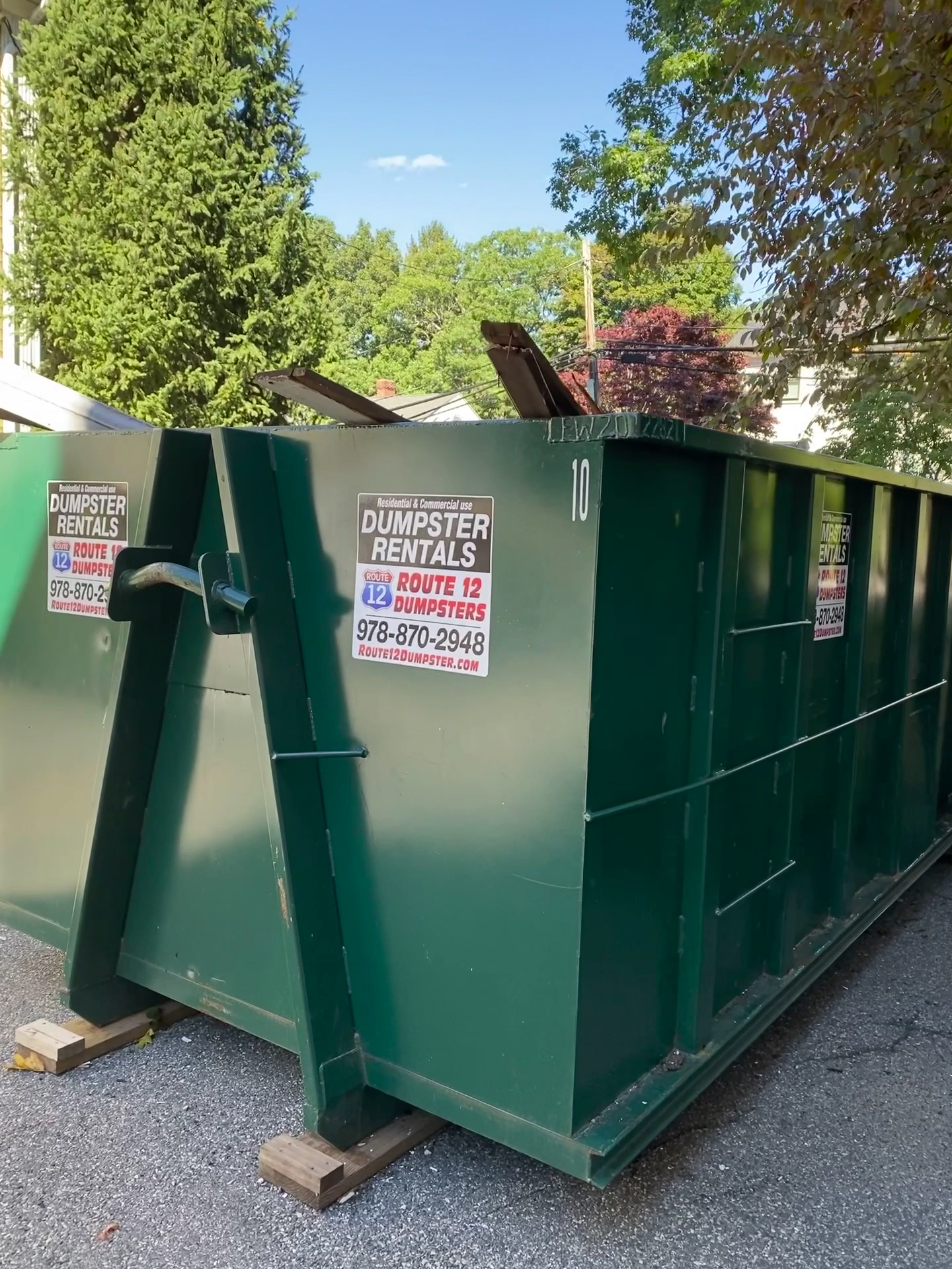 Green Route 12 dumpsters on a residential street